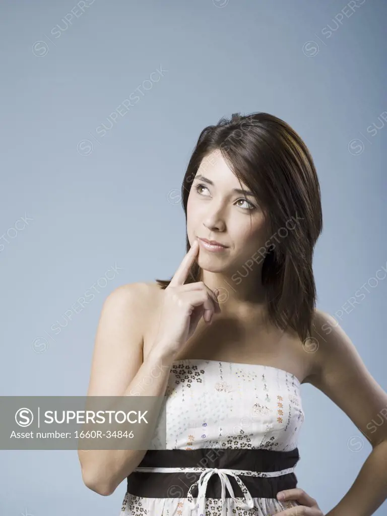 Woman with arms crossed looking up