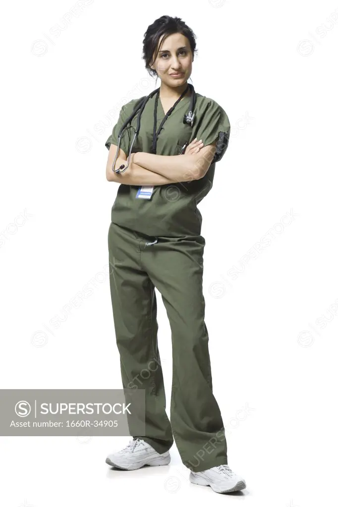 Woman standing in scrubs smiling
