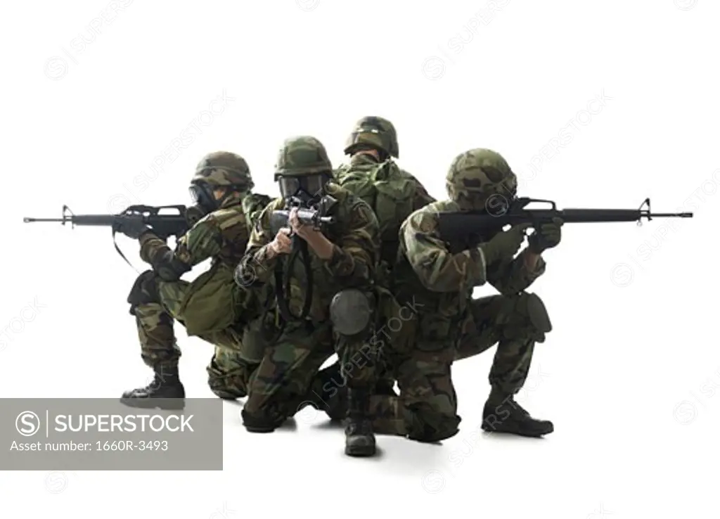Four soldiers kneeling with their guns