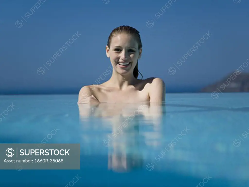 Woman in outdoor pool smiling