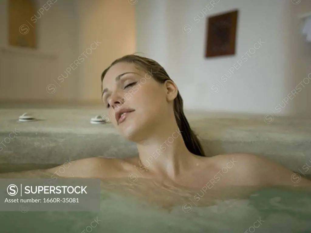 Woman in hot tub indoors