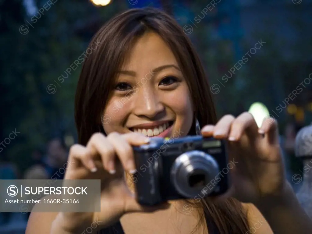 Woman taking a photograph smiling