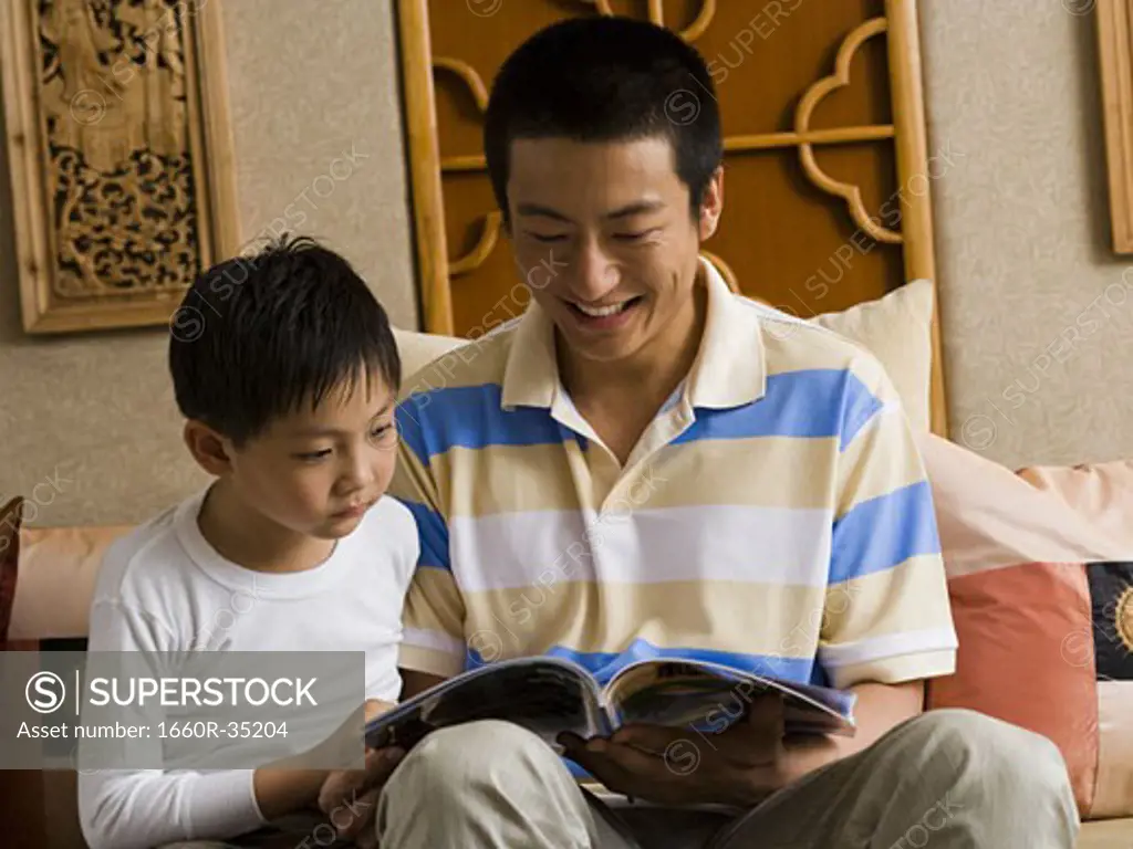 Father and son reading magazine