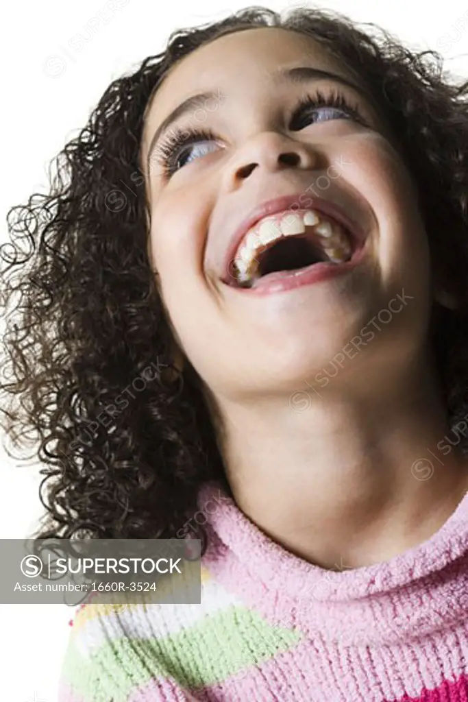 Close-up of a girl looking up and laughing