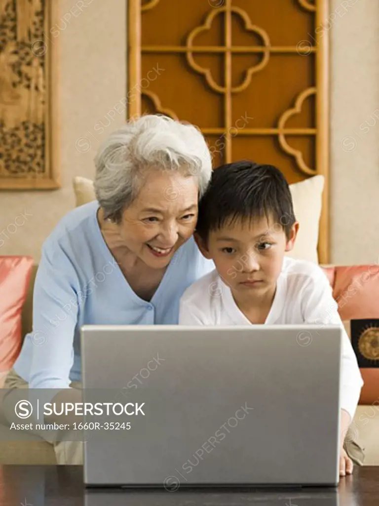 Grandmother and grandson with laptop