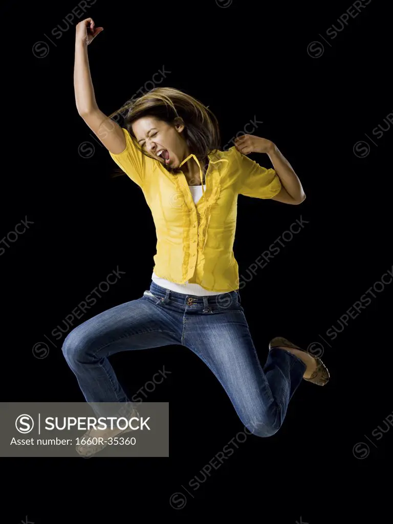 Woman leaping with arms raised