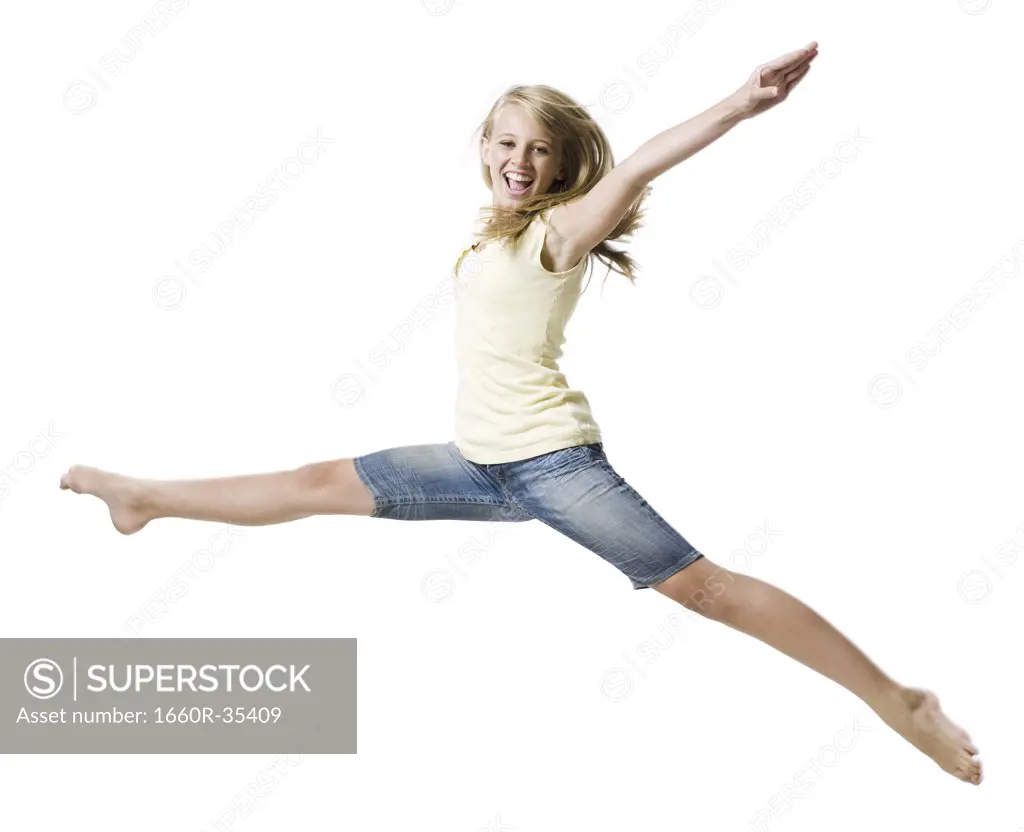 Girl leaping and smiling with arms up