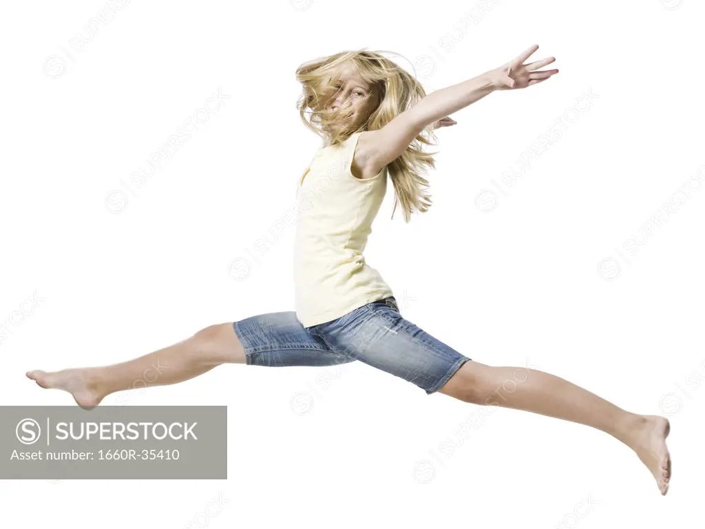 Girl leaping and smiling with arms up