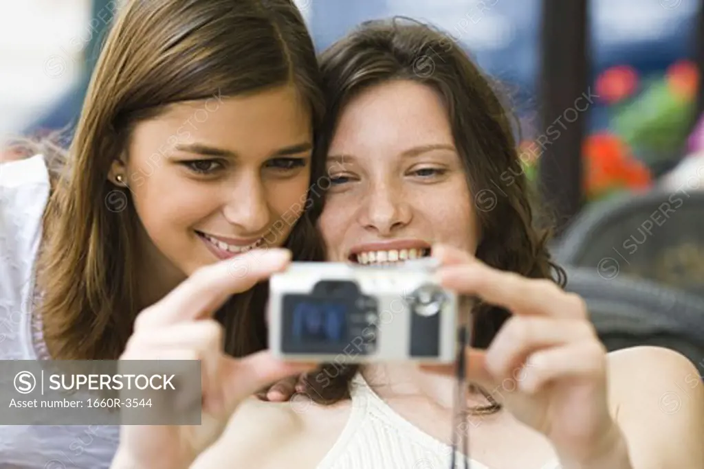 Two teenage girls taking a picture together