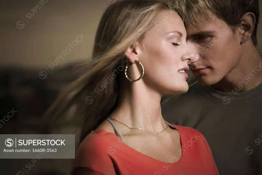 Close-up of a teenage couple with their eyes closed