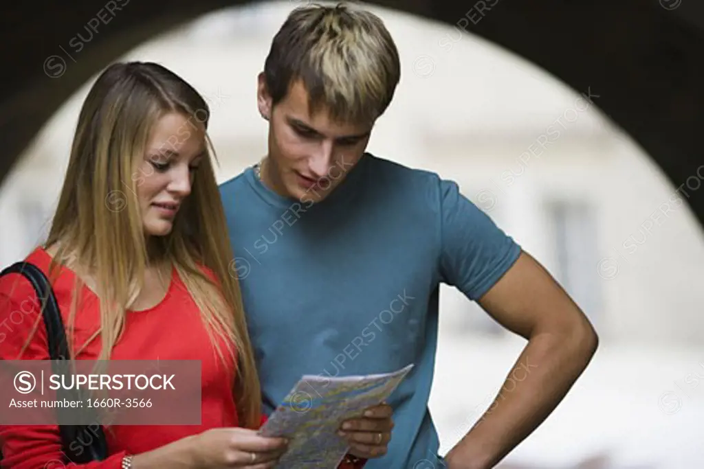 Teenage couple looking at a map