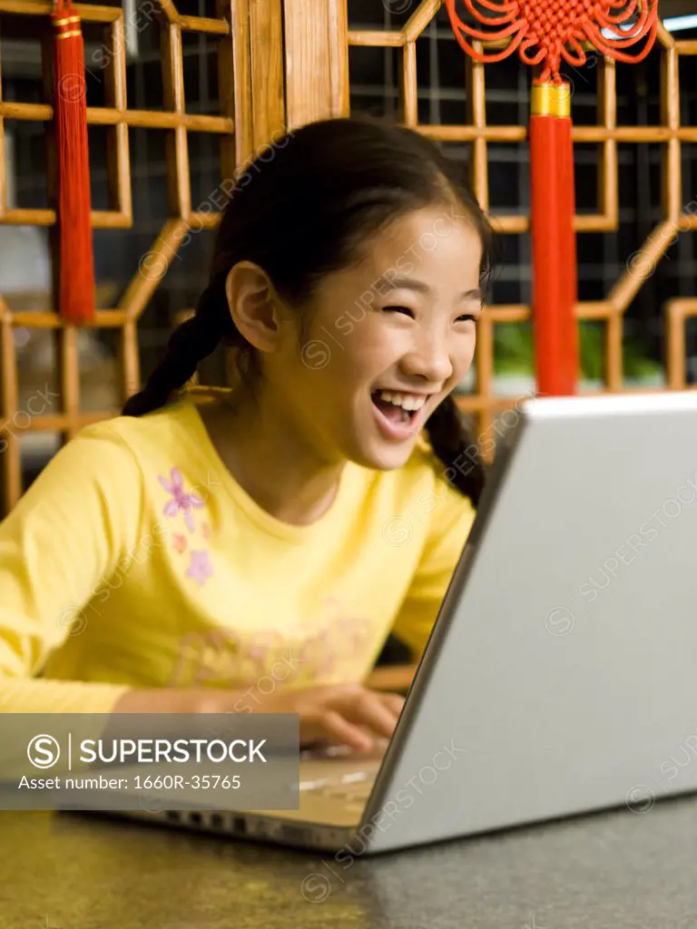 Girl sitting with laptop smiling