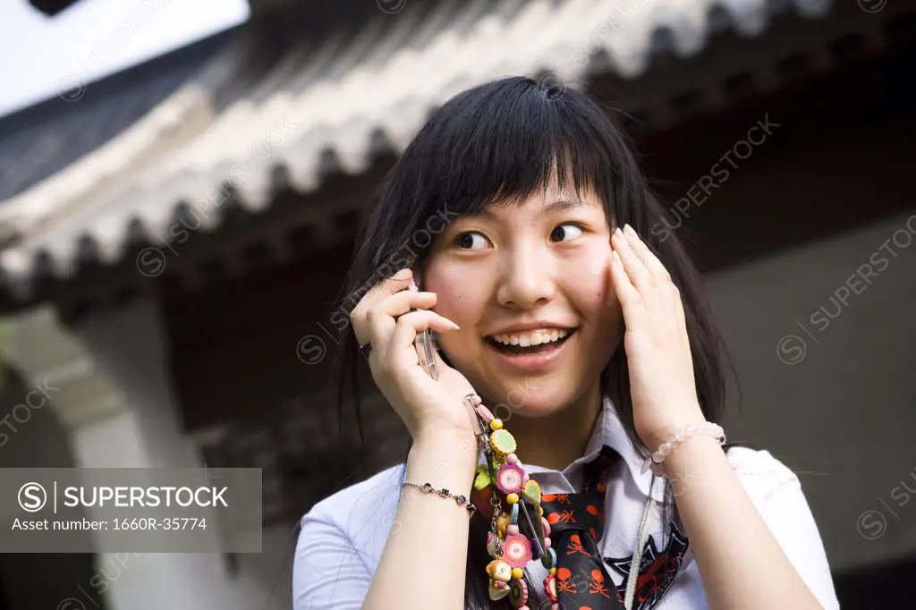 Teenage girl in school uniform smiling with mp3 player