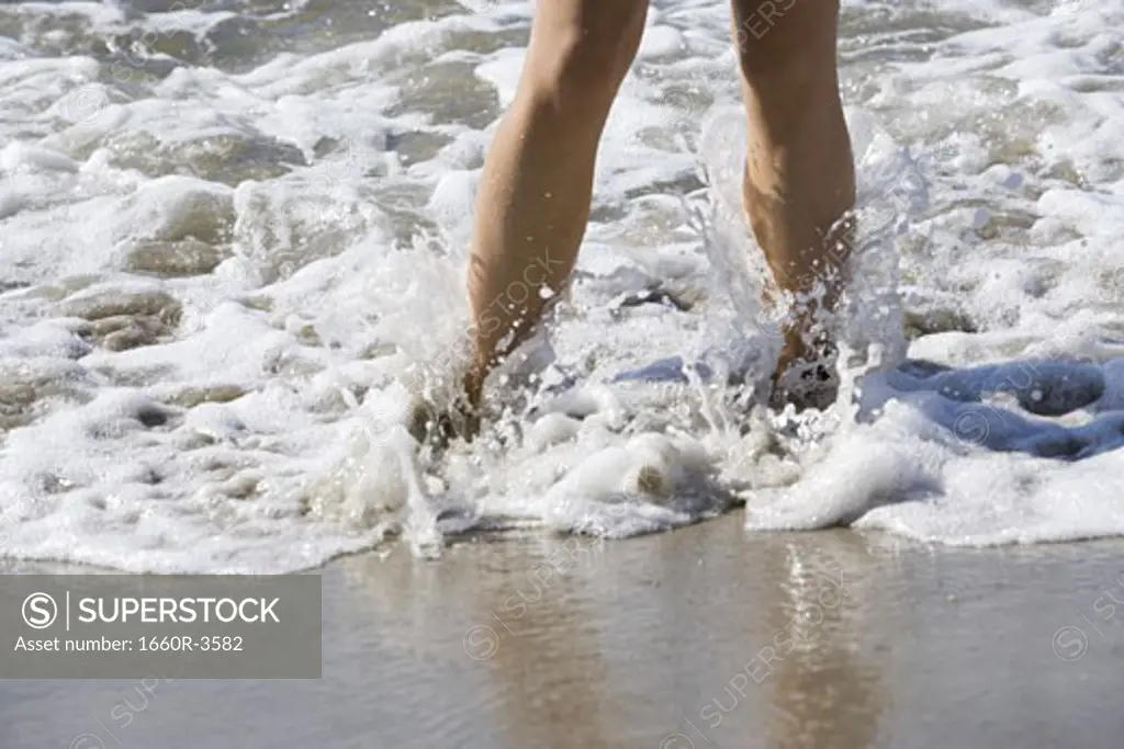 Close-up of a woman's legs in the surf