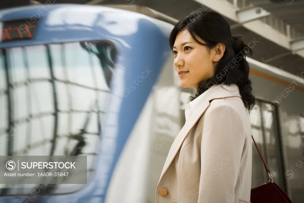 Businesswoman on subway platform smiling