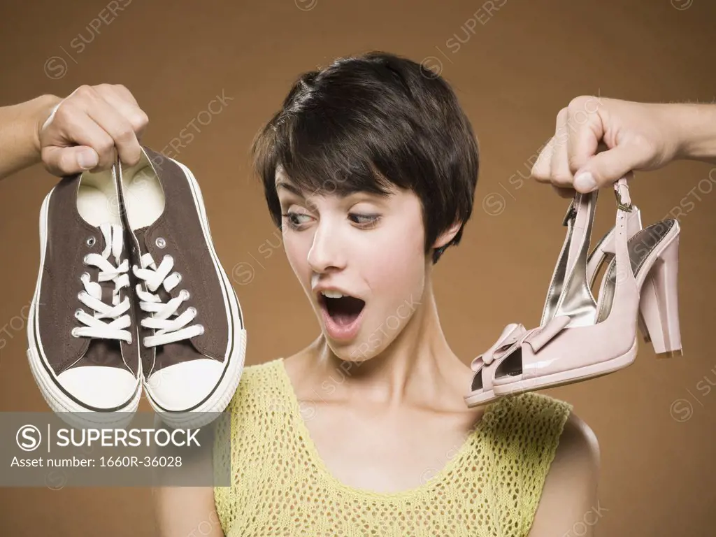 Woman with running shoes and pumps deciding