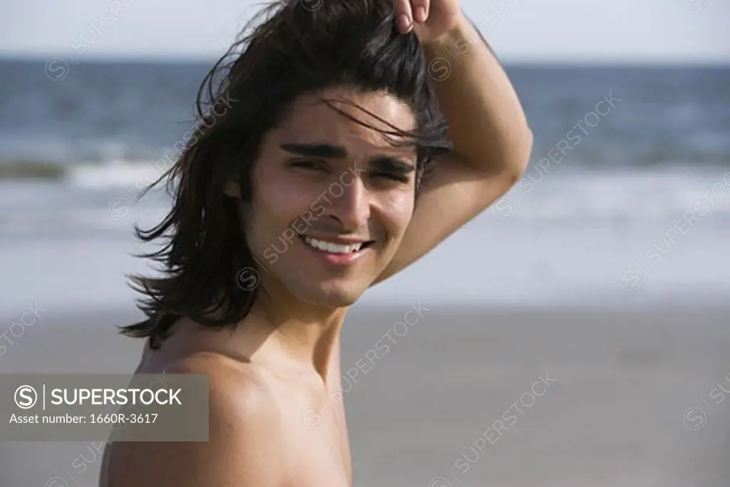 Portrait of a young man smiling on the beach