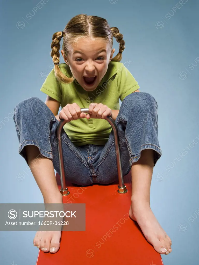 Child riding on a see saw.