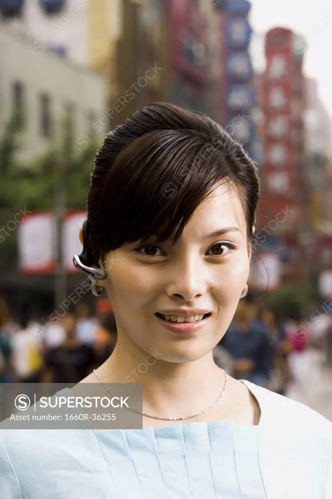 Woman with a cell phone earpiece.