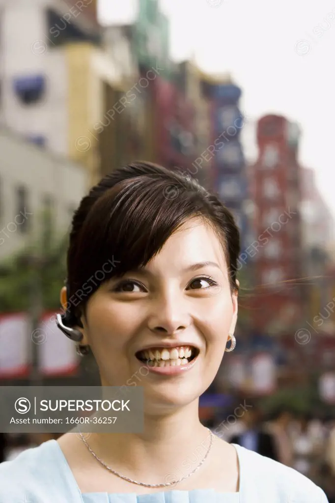 Woman with a cell phone earpiece.