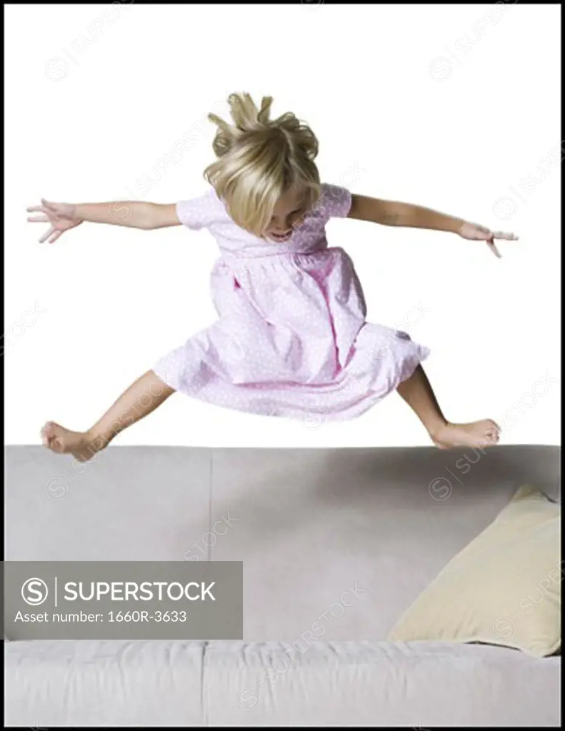 Girl jumping on a couch