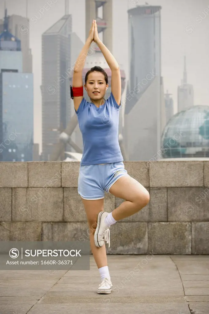 Woman exercising while listening to mp3 player.