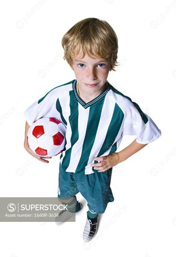 High angle view of a boy holding a soccer ball
