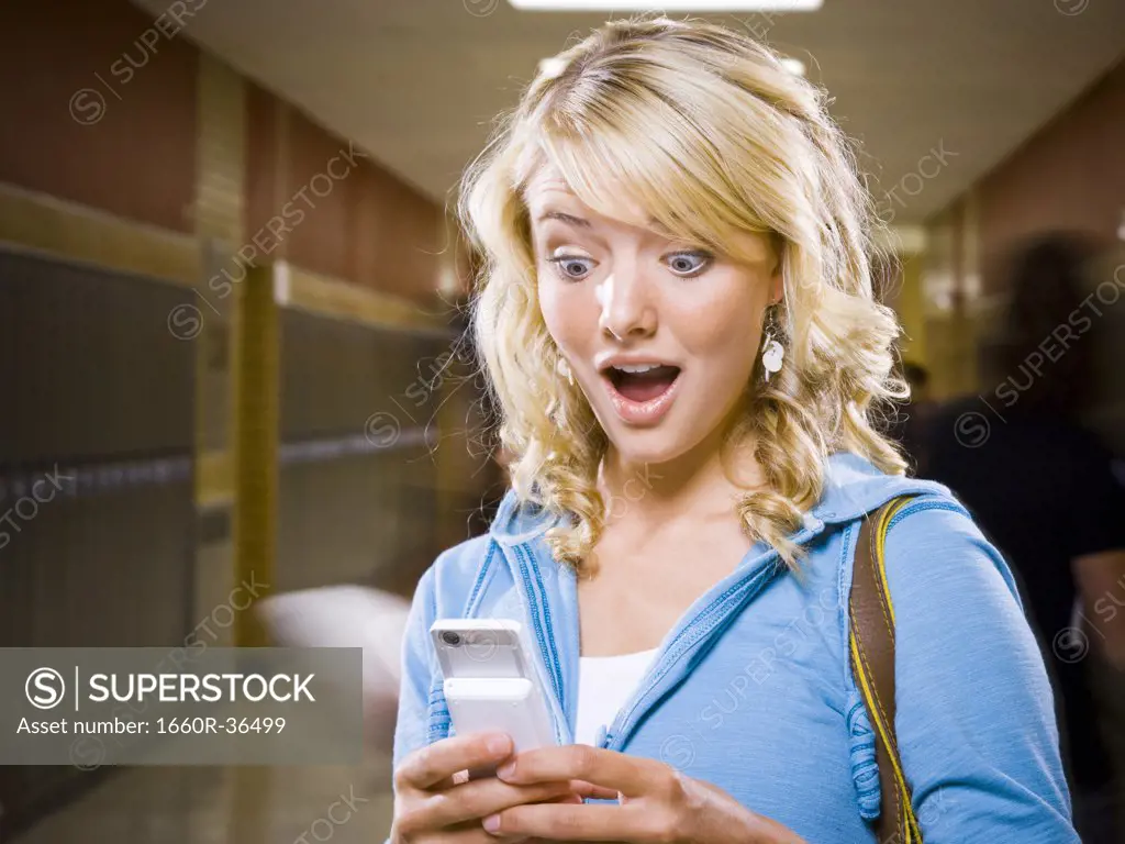 High School girl at school text messaging.