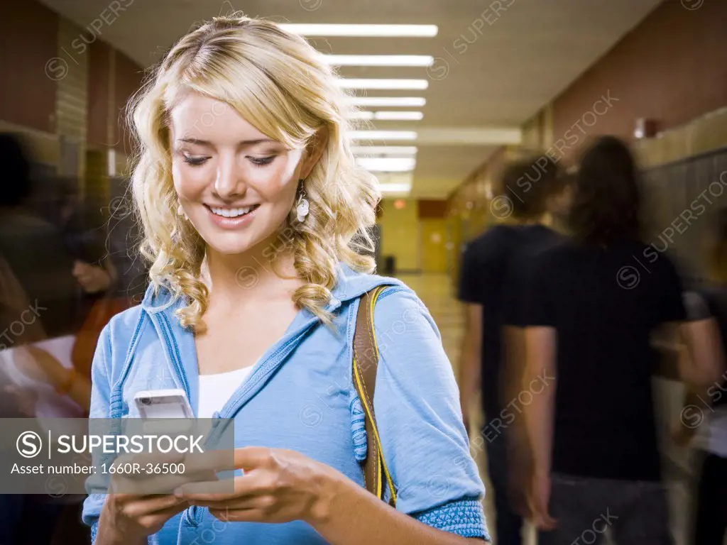High School girl at school text messaging.