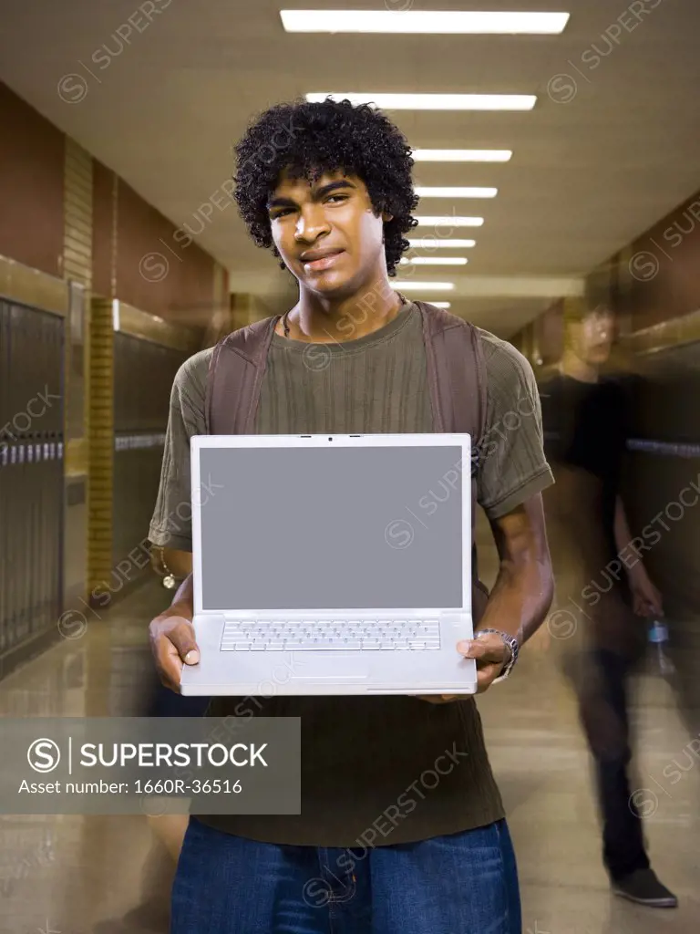 High School boy at school with a notebook computer.