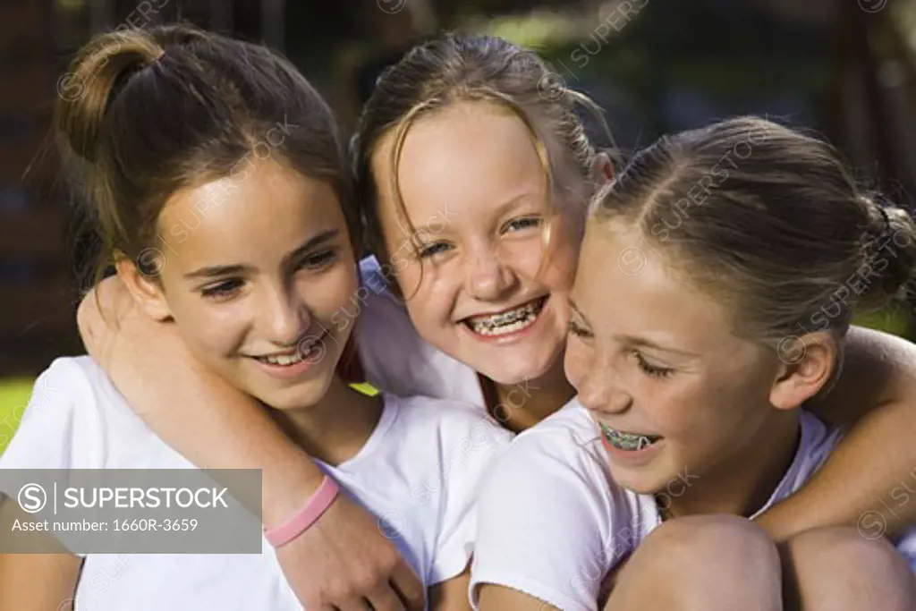 Close-up of three girls smiling