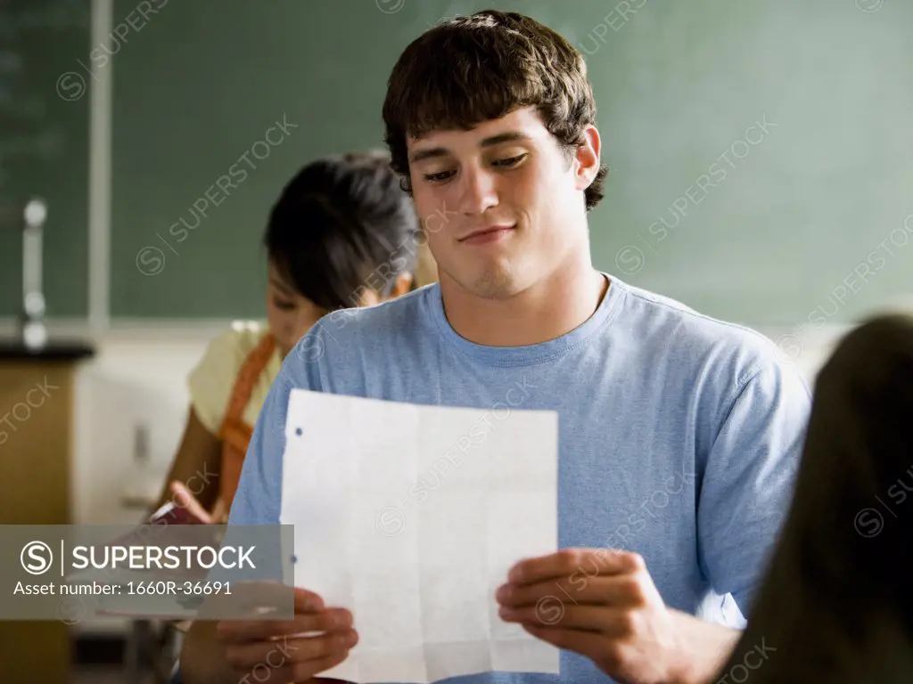 Students passing notes in a classroom.