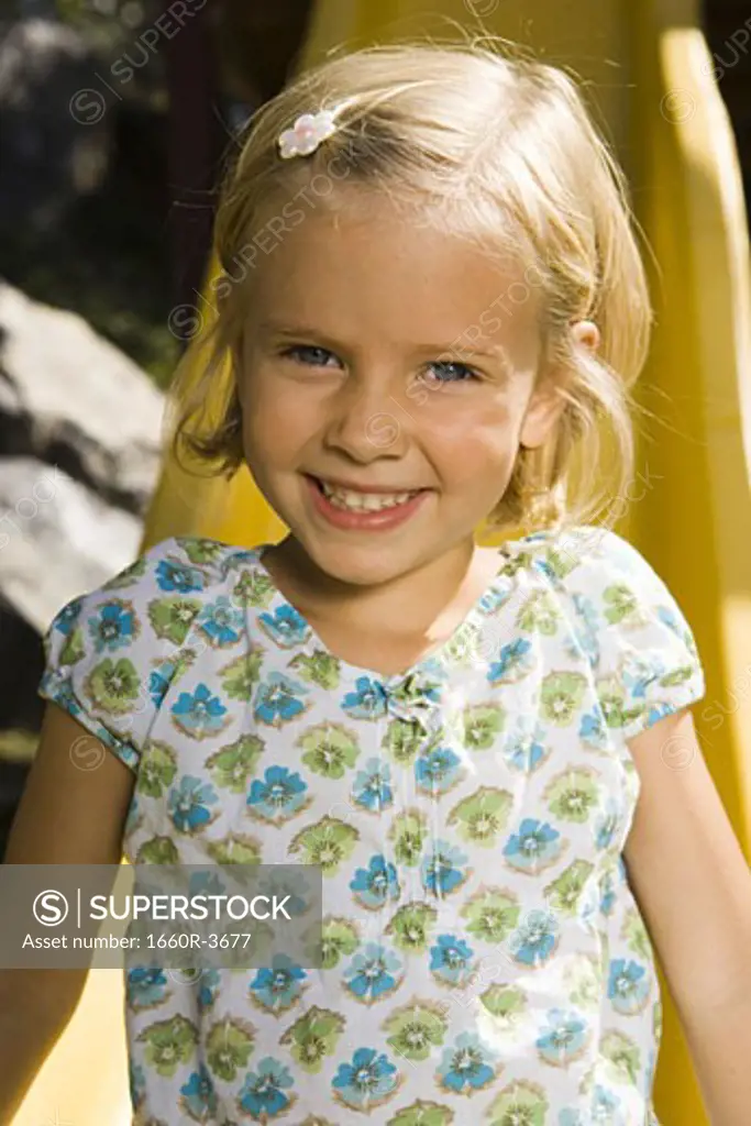 Portrait of a girl sitting on a slide