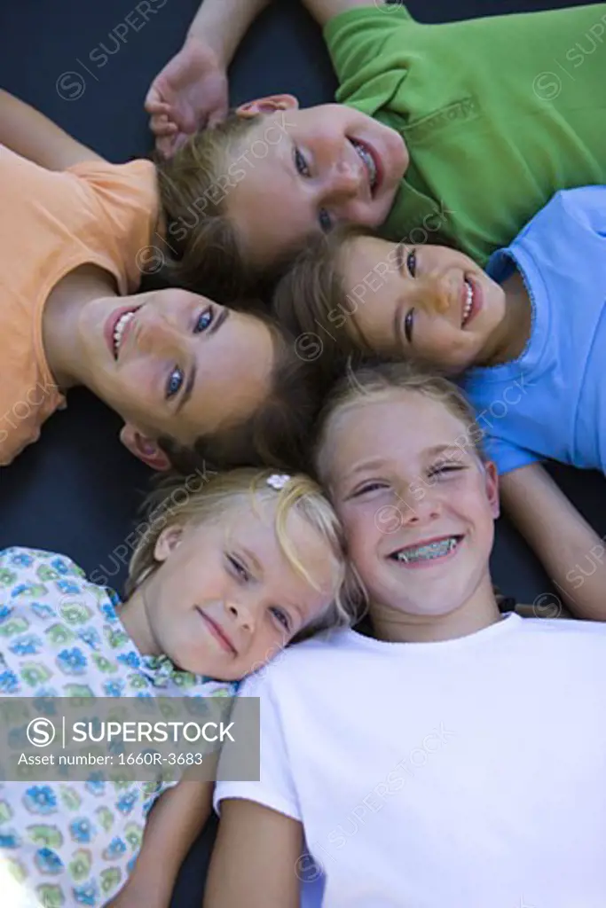 High angle view of five girls lying together