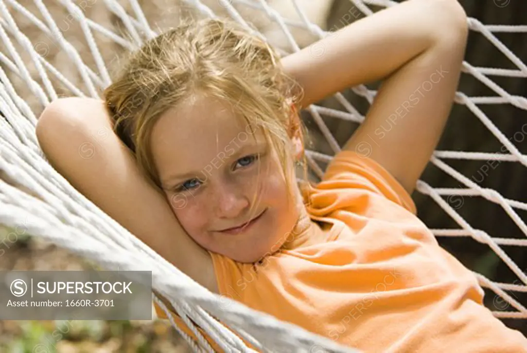 Portrait of a girl lying in a hammock