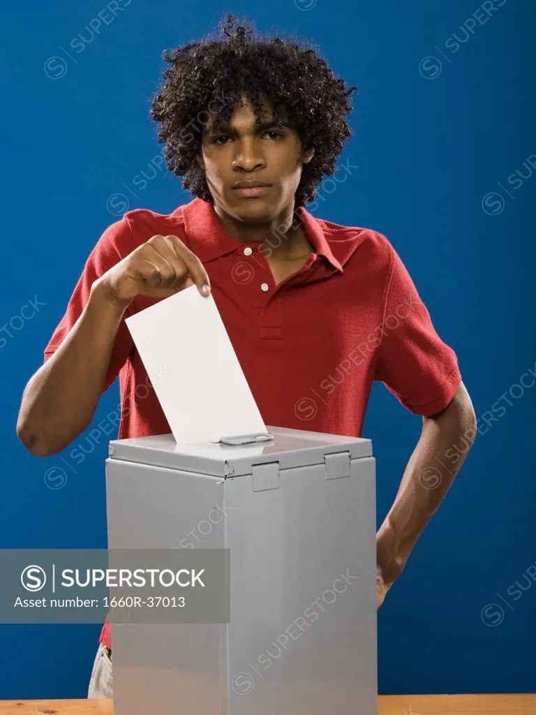 young man casting a ballot.