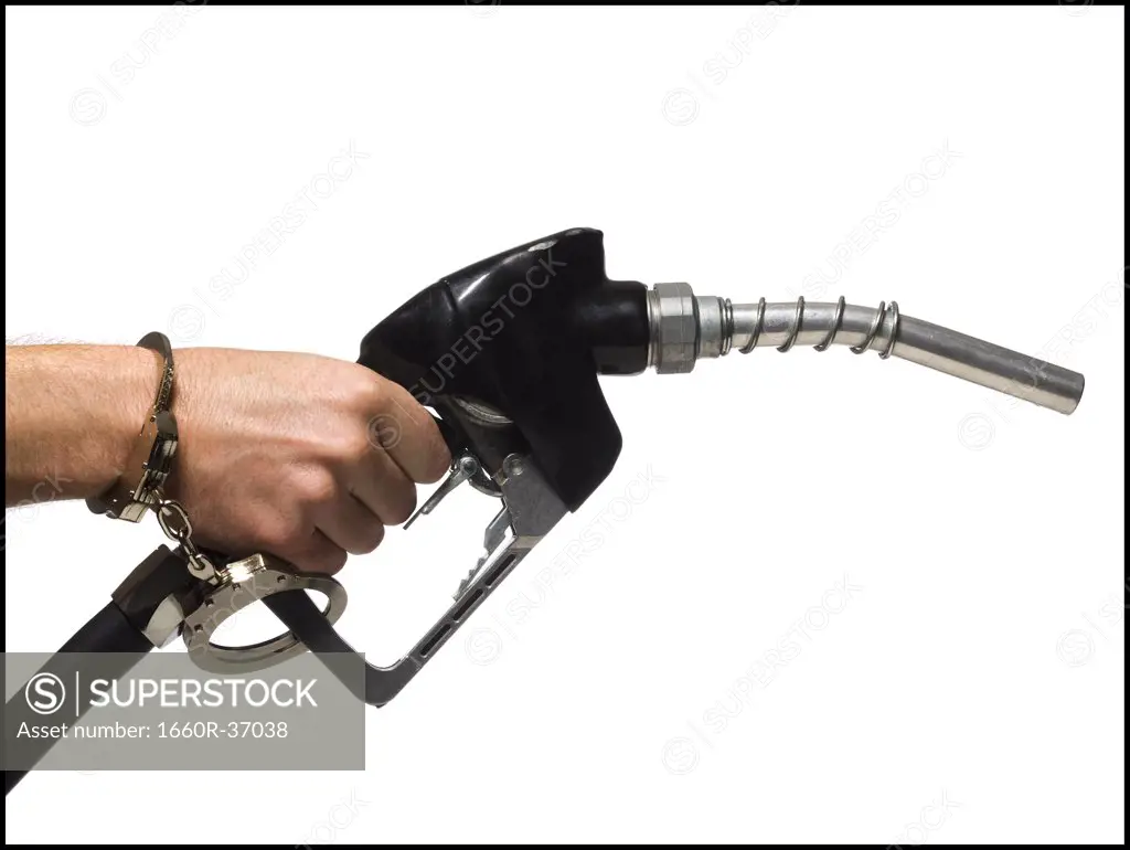 Hand handcuffed to a gas pump.