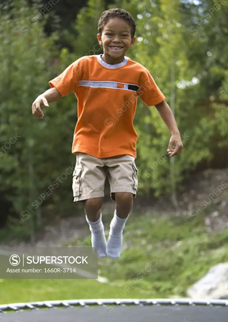 Portrait of a boy jumping on a trampoline