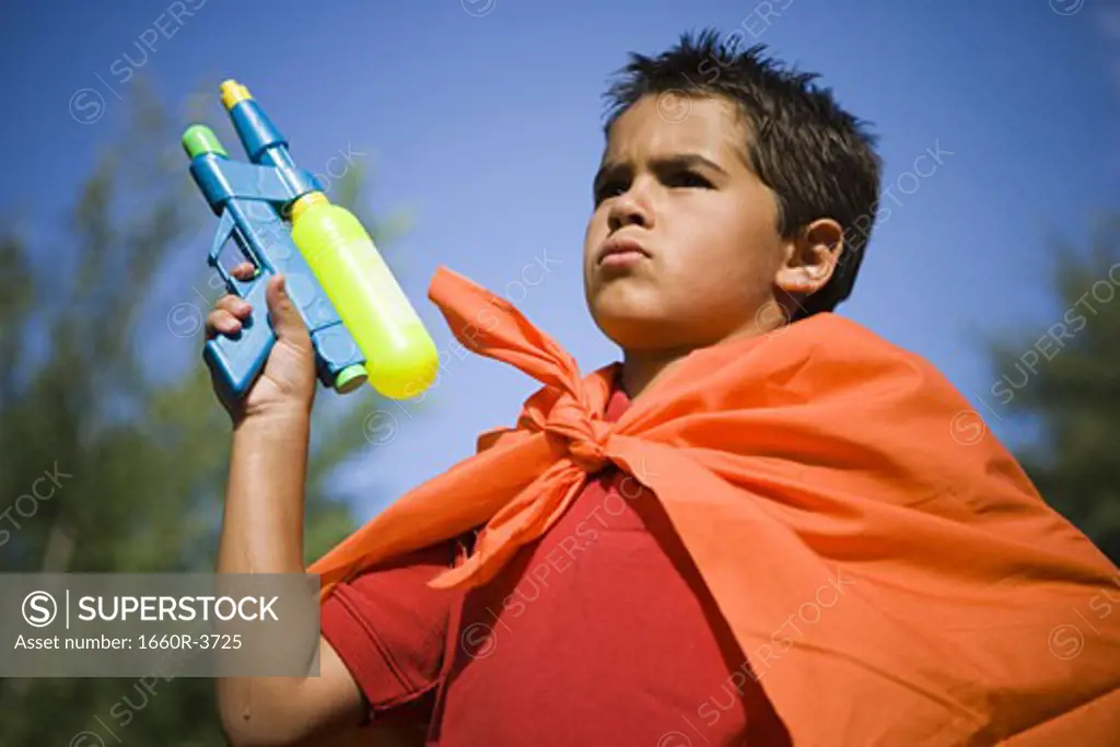 Low angle view of a boy holding a squirt gun