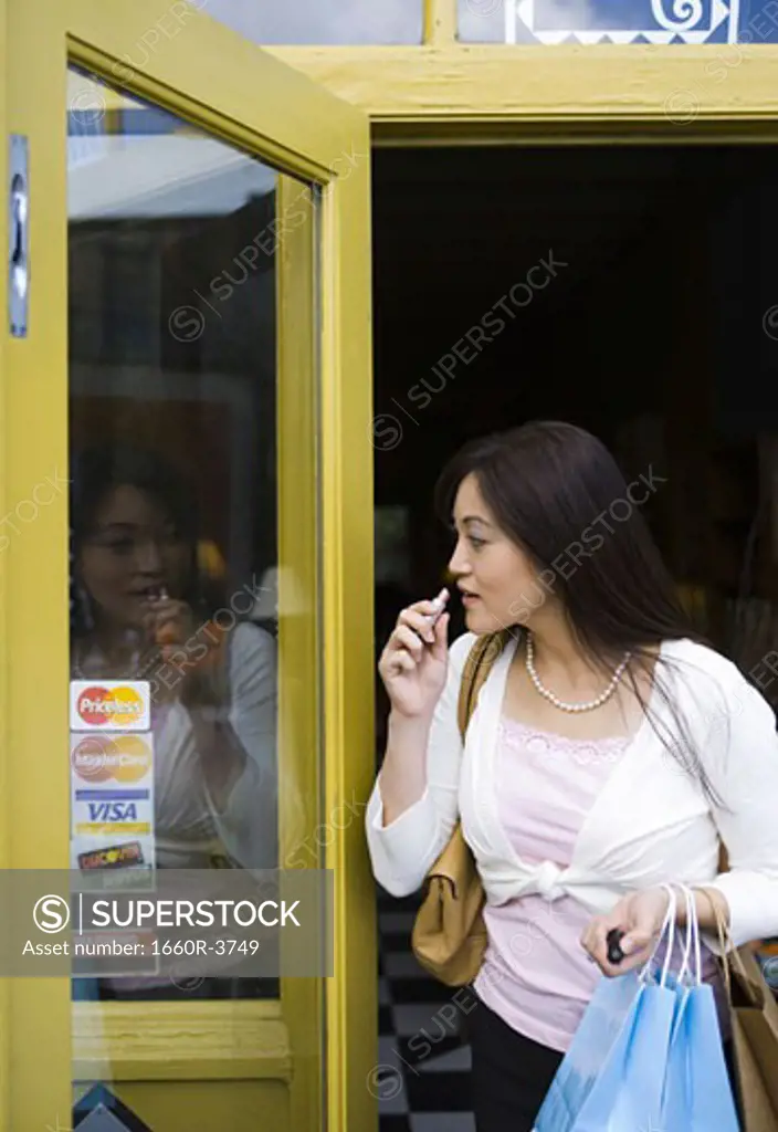 Young woman stepping out of a store