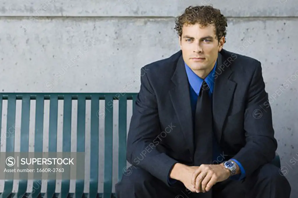 Portrait of a businessman sitting on a bench