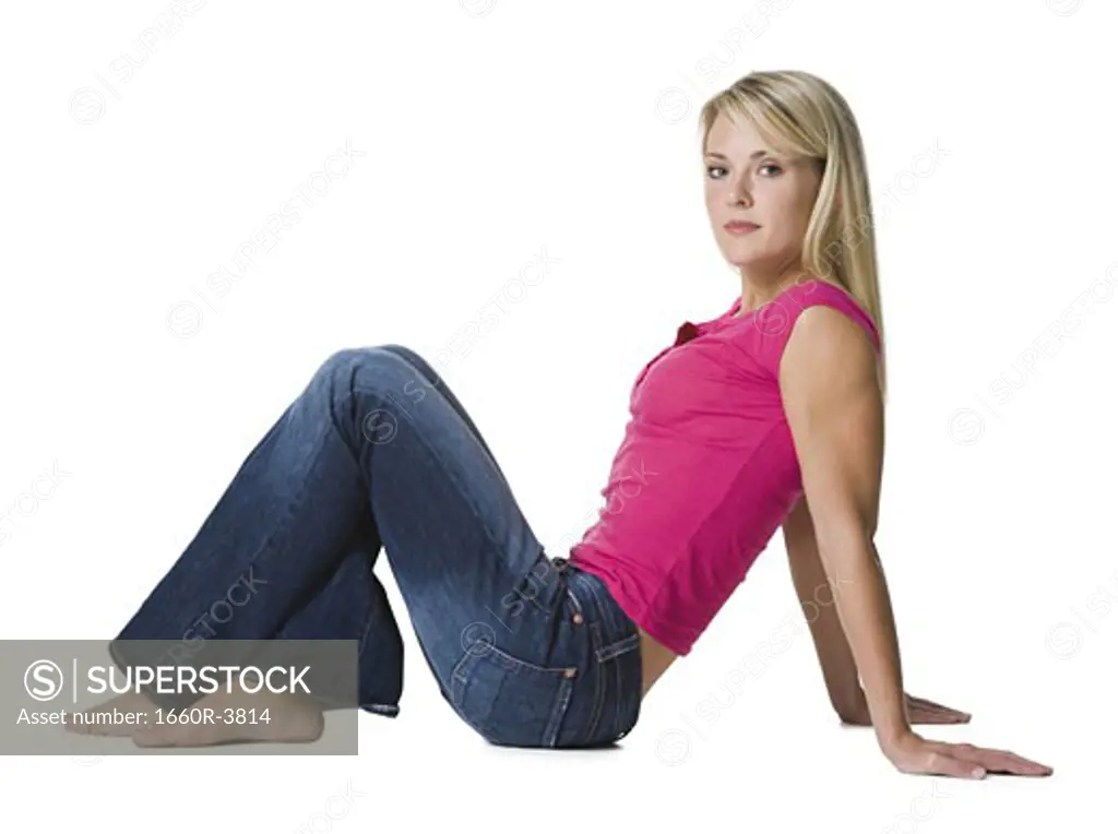 Profile of a young woman sitting on the floor