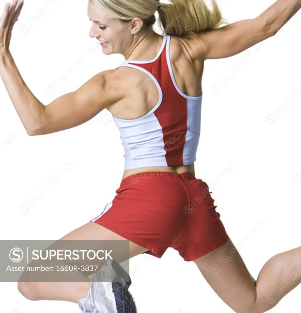 Rear view of a young woman jumping