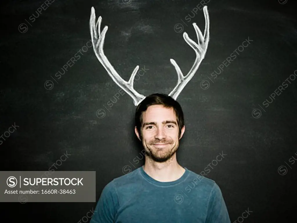 man against a chalkboard