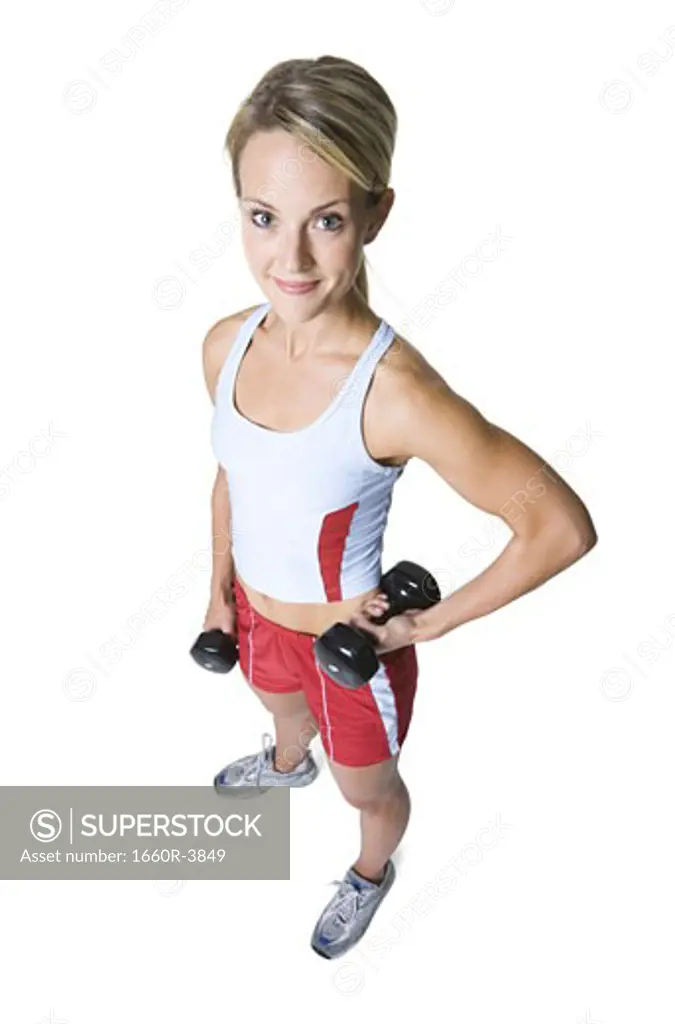 High angle view of a young woman holding dumbbells