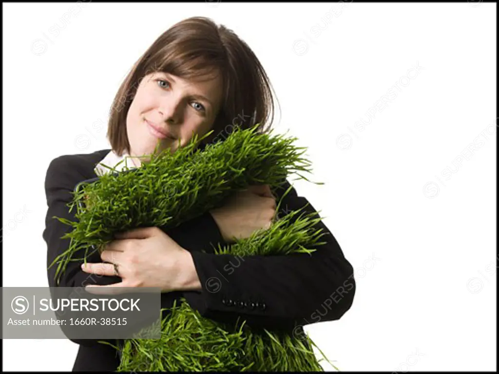 businessperson holding a patch of grass
