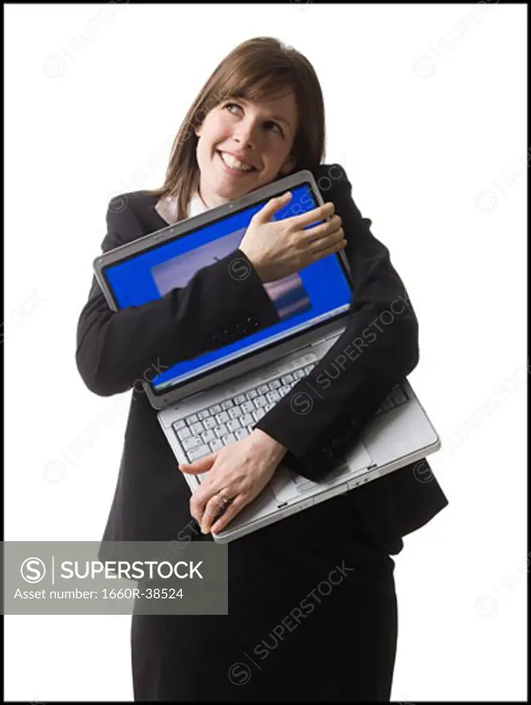 businessperson holding a laptop computer