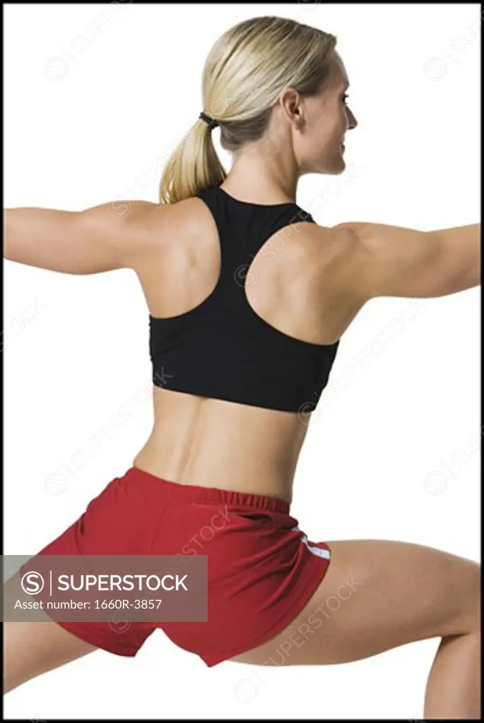 Rear view of a young woman stretching