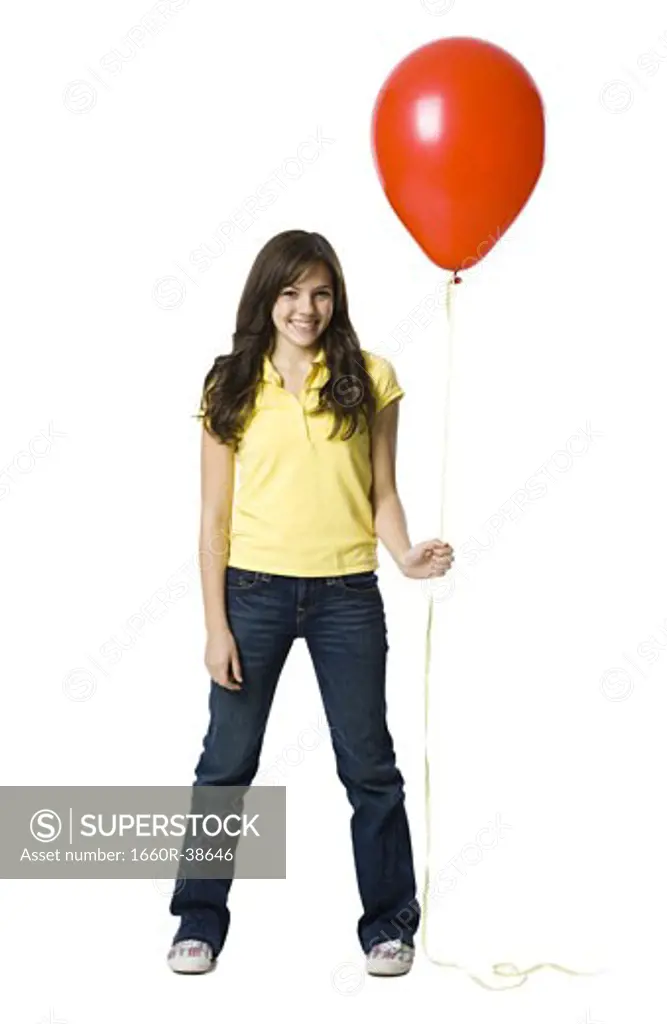 young woman holding a red balloon