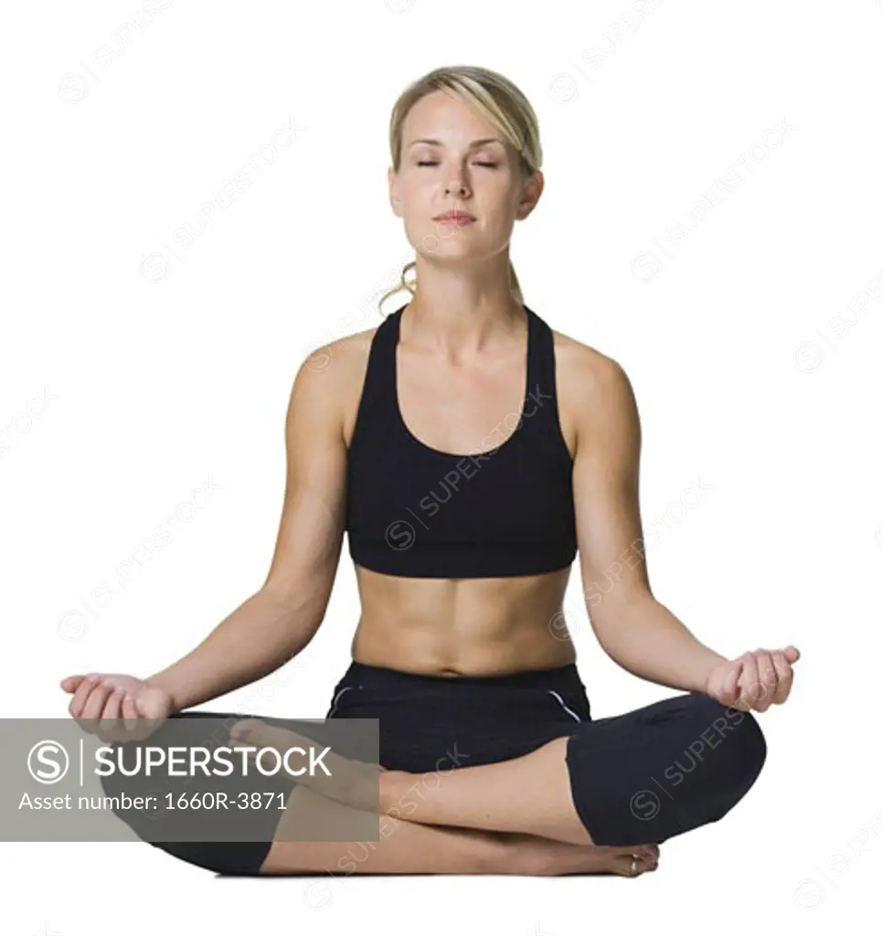 Young woman doing yoga with her legs crossed